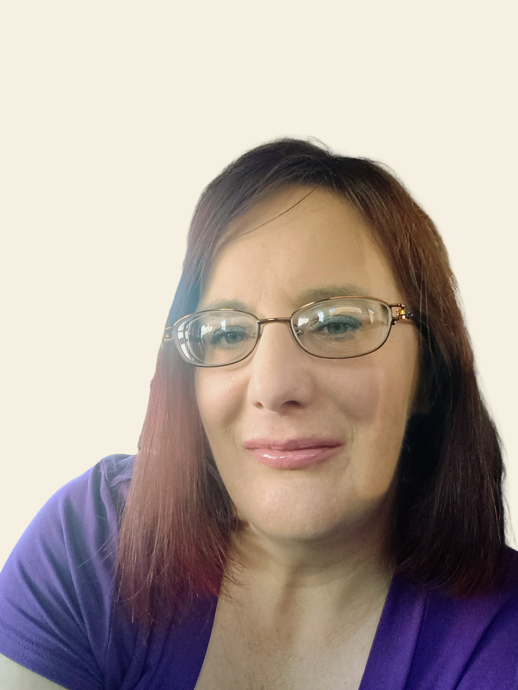 A woman with straight, shoulder-length brown hair and glasses is smiling softly. She is wearing a purple top and has a light background behind her.